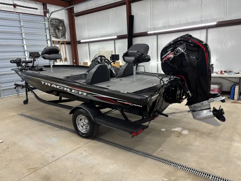 Slide: The Image of 2023 Tracker 190TX TE boat in a garage. - 7