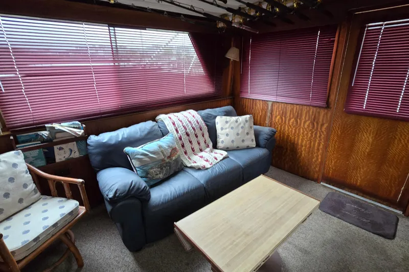 Slide: The Image of Interior of 1975 Hatteras 46 Convertible with cozy seating and wooden accents. - 13
