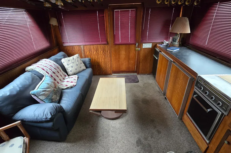 Slide: The Image of Interior of 1975 Hatteras 46 Convertible yacht with cozy seating and kitchen area. - 14