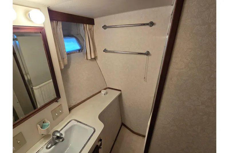 Slide: The Image of Bathroom interior of 1975 Hatteras 46 Convertible yacht, featuring sink and window. - 18