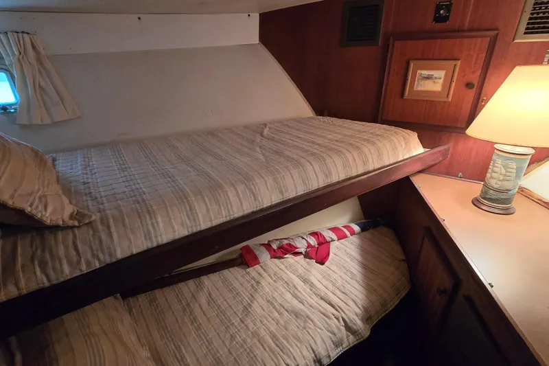 Slide: The Image of Interior cabin of 1975 Hatteras 46 Convertible with bunk beds and nautical decor. - 19