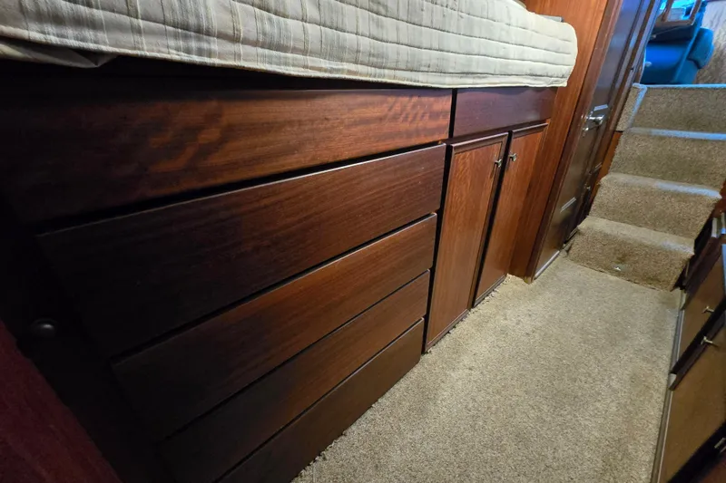 Slide: The Image of Interior of 1975 Hatteras 46 Convertible yacht with wooden cabinetry and carpeted flooring. - 23