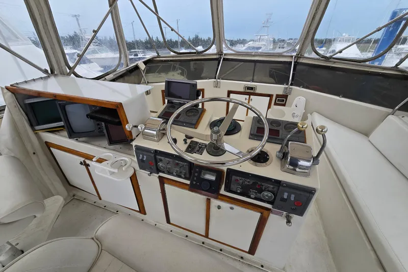 Slide: The Image of Helm of 1975 Hatteras 46 Convertible yacht with steering wheel and navigation equipment. - 25