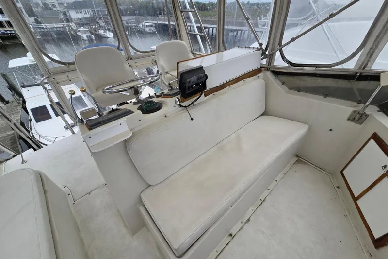 Slide: The Image of 1975 Hatteras 46 Convertible yacht helm with seating and navigation equipment. - 27