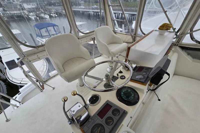 Slide: The Image of Helm of 1975 Hatteras 46 Convertible yacht with steering wheel and navigation instruments. - 28
