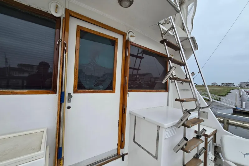 Slide: The Image of 1975 Hatteras 46 Convertible boat deck with ladder and wooden door. - 33