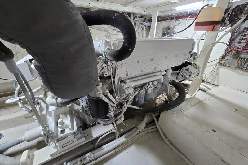 Slide: The Image of Engine room of a 1975 Hatteras 46 Convertible yacht, showcasing detailed machinery. - 37