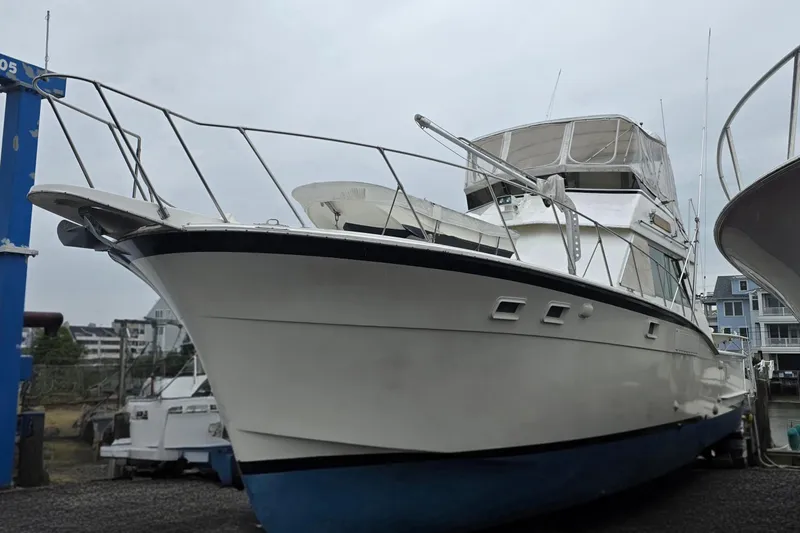 Slide: The Image of 1975 Hatteras 46 Convertible yacht on dry dock, showcasing its sleek design. - 4