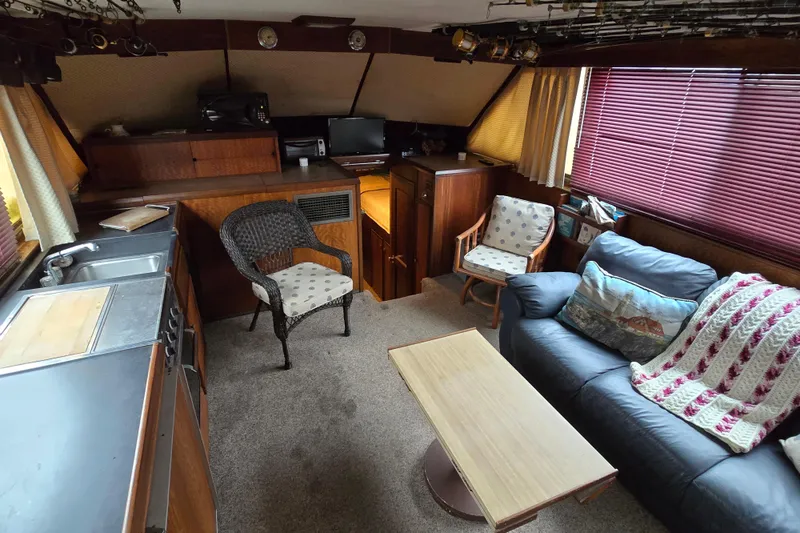 Slide: The Image of Interior of a 1975 Hatteras 46 Convertible yacht with cozy seating and kitchenette. - 6