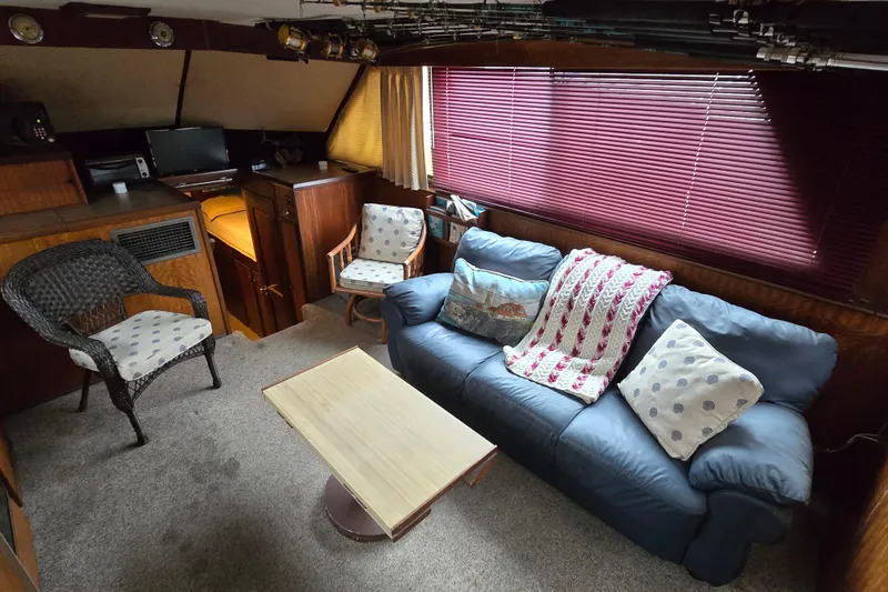 Slide: The Image of Interior of 1975 Hatteras 46 Convertible yacht with cozy seating and decor. - 7
