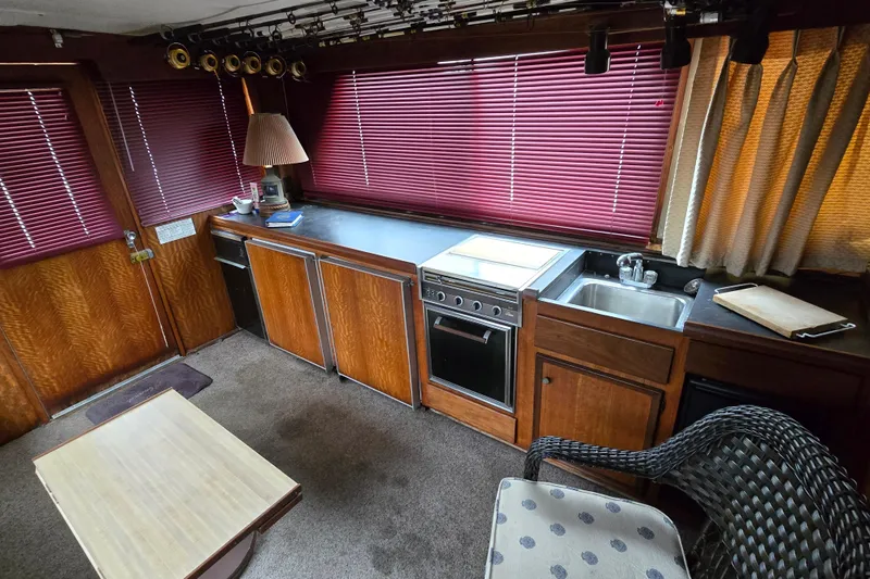 Slide: The Image of Interior of 1975 Hatteras 46 Convertible yacht with kitchen and seating area. - 8