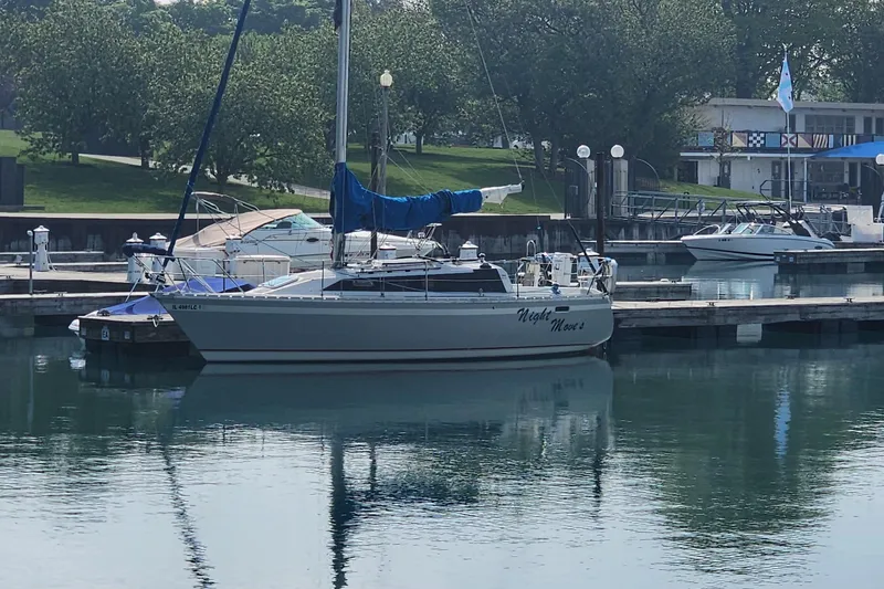 The Image of 1988 O'Day 302 sailboat docked in a serene marina setting. - 0