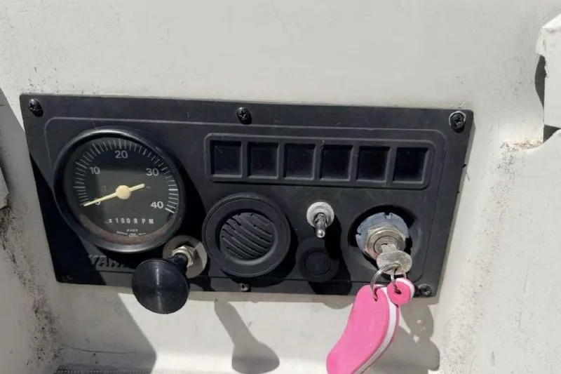Slide: The Image of Control panel of a 1988 O'Day 302 sailboat with key and RPM gauge. - 16