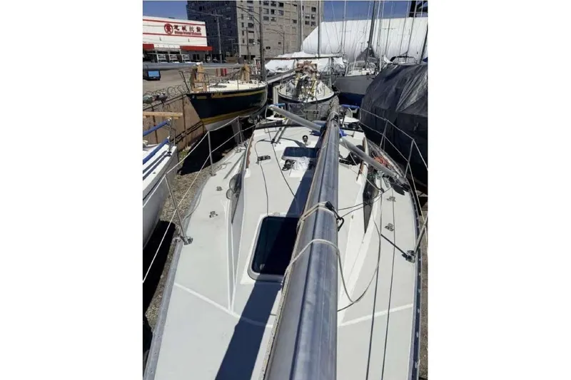 Slide: The Image of 1988 O'Day 302 sailboat docked, surrounded by other boats in a marina. - 17