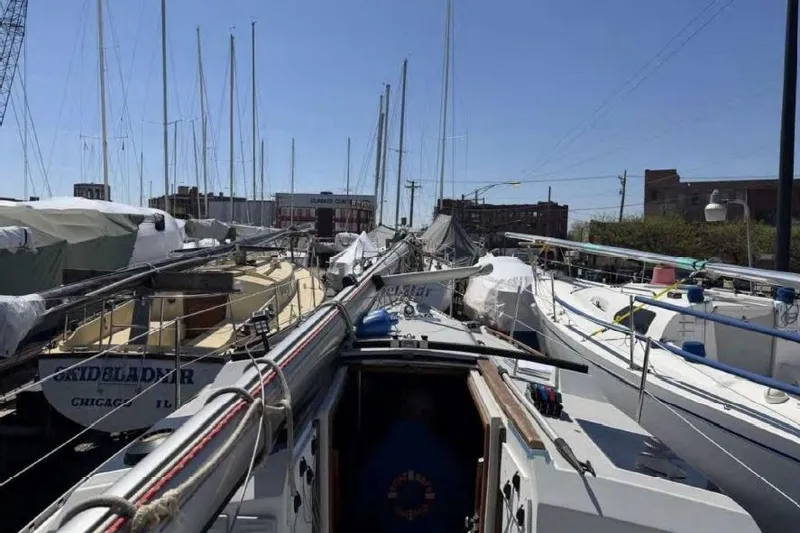 Slide: The Image of 1988 O'Day 302 sailboats docked in a marina, surrounded by other vessels. - 19