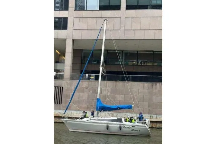Slide: The Image of Sailboat O'Day 302, 1988 model, docked near a modern building. - 2