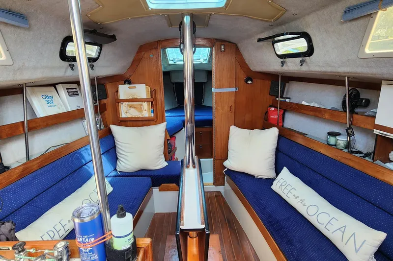 Slide: The Image of Interior of 1988 O'Day 302 sailboat with blue seating and nautical decor. - 20