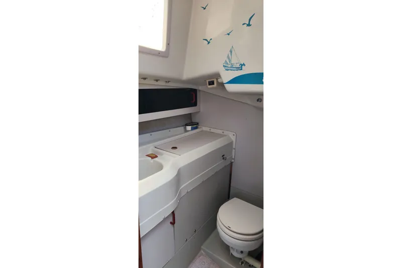 Slide: The Image of 1988 O'Day 302 boat bathroom interior with sink and toilet. - 28