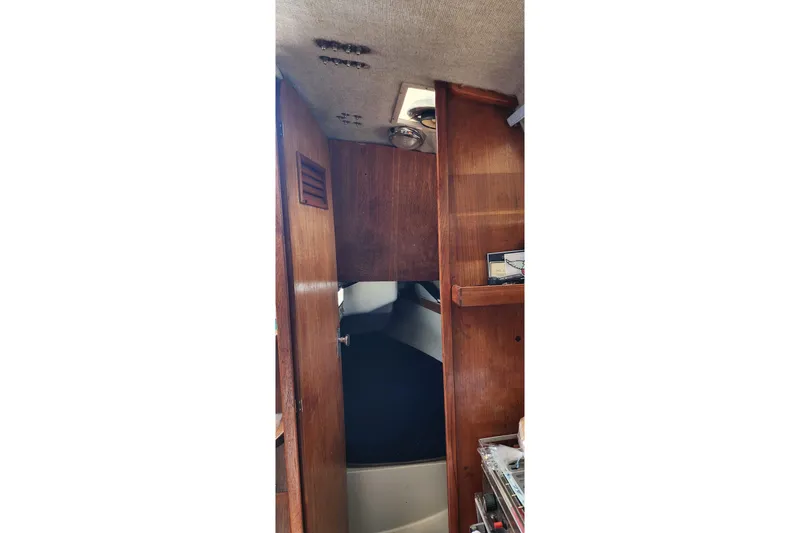 Slide: The Image of Interior view of a 1988 O'Day 302 sailboat cabin with wooden paneling. - 29