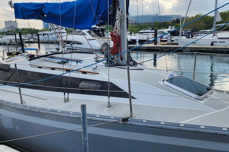Slide: The Image of 1988 O'Day 302 sailboat docked at a marina, featuring blue sail cover. - 3