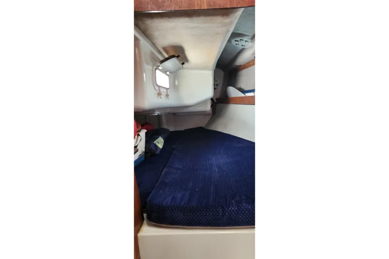 Slide: The Image of Interior cabin of a 1988 O'Day 302 sailboat with blue bedding. - 30