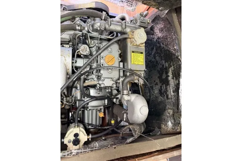 Slide: The Image of 1988 O'Day 302 engine close-up, showcasing intricate mechanical components and wiring. - 32