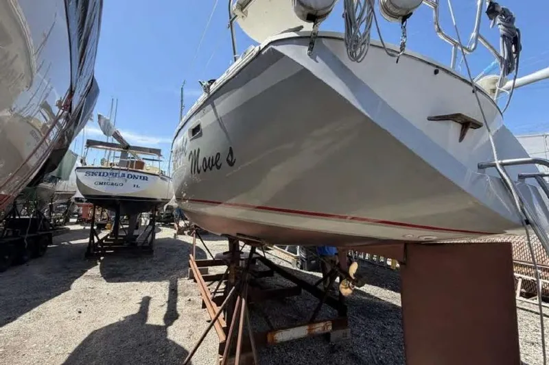 Slide: The Image of 1988 O'Day 302 sailboat on stands in a boatyard, sunny day. - 5