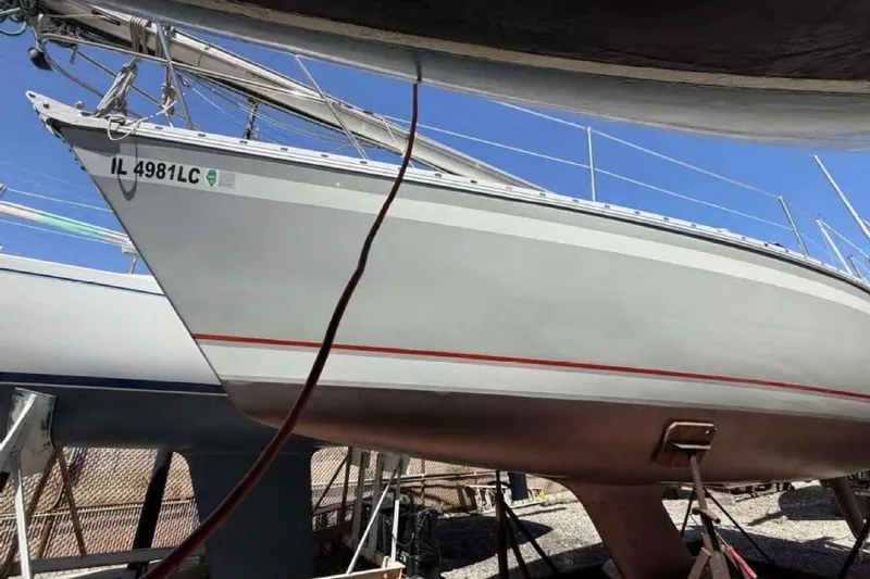 Slide: The Image of 1988 O'Day 302 sailboat on dry dock, hull visible, registration IL 4981LC. - 6