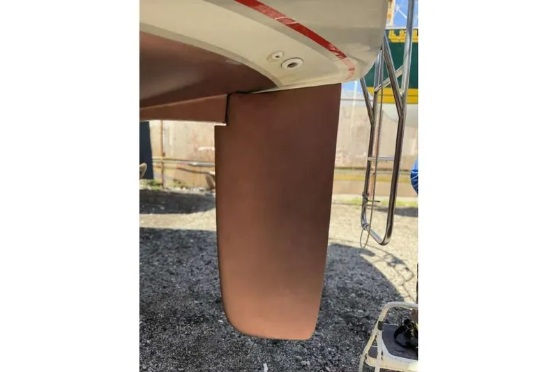 Slide: The Image of 1988 O'Day 302 sailboat rudder and ladder detail in a boatyard setting. - 8
