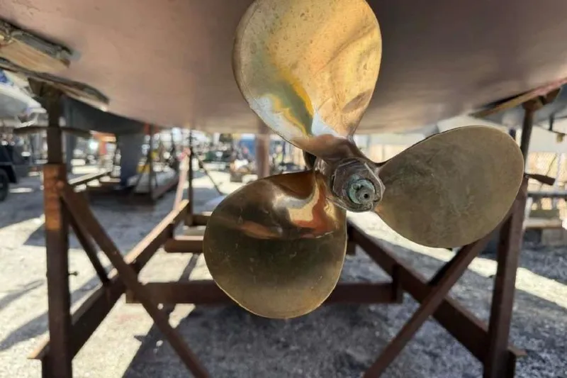 Slide: The Image of Close-up of a brass propeller on a 1988 O'Day 302 sailboat in dry dock. - 9