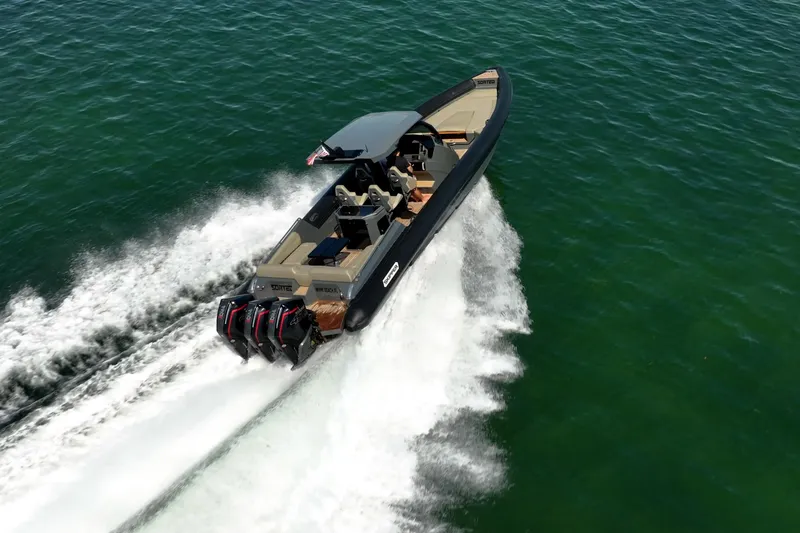 Slide: The Image of 2023 Skipper-BSK 38NC boat speeding on open water, showcasing powerful engines and sleek design. - 10