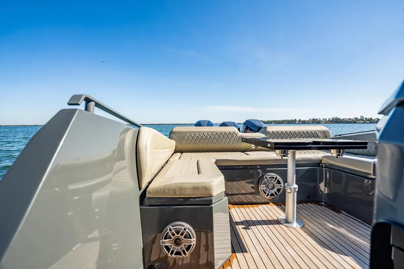 Slide: The Image of Luxurious 2023 Skipper-BSK 38NC boat interior with cushioned seating and table on open water. - 100