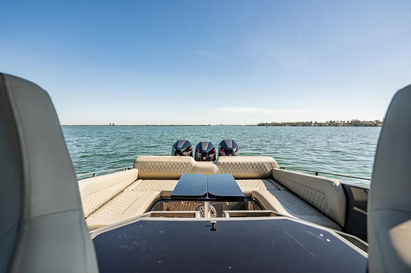Slide: The Image of Luxurious 2023 Skipper-BSK 38NC boat interior with twin engines on a serene water backdrop. - 105