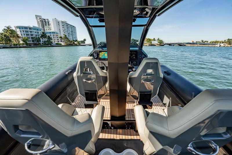 Slide: The Image of Interior view of 2023 Skipper-BSK 38NC boat with modern seating and waterfront backdrop. - 109