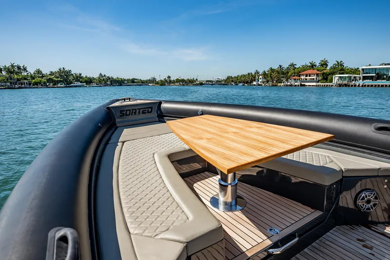 Slide: The Image of Luxury Skipper-BSK 38NC boat interior with wooden table, 2023 model, on a scenic waterway. - 118