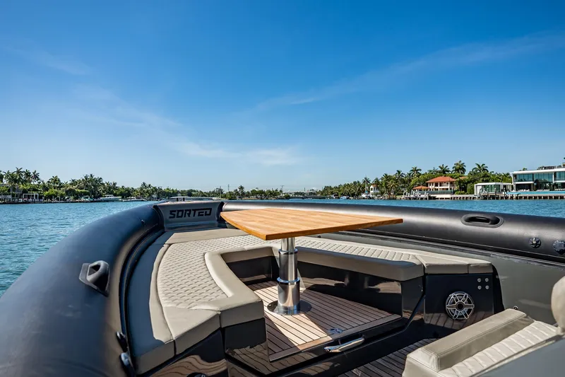 Slide: The Image of 2023 Skipper-BSK 38NC boat with seating and table on a sunny day. - 120