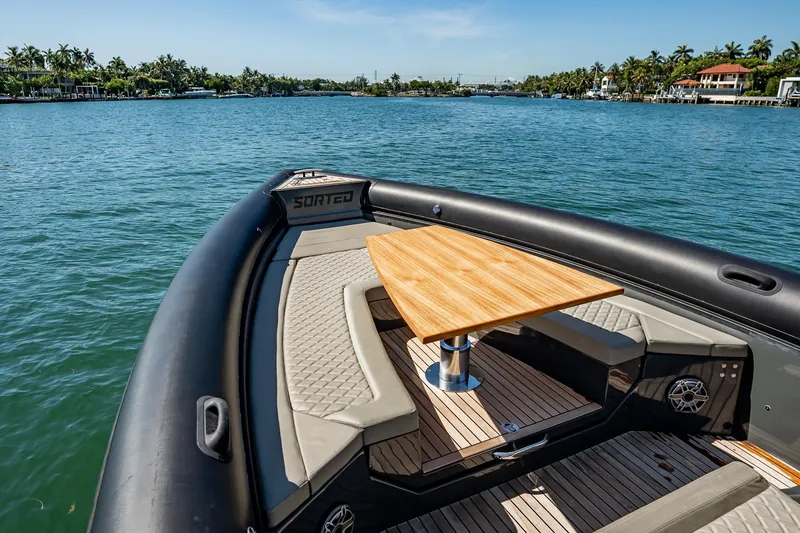 Slide: The Image of Luxury Skipper-BSK 38NC boat interior with wooden table, 2023 model, on a serene waterway. - 121