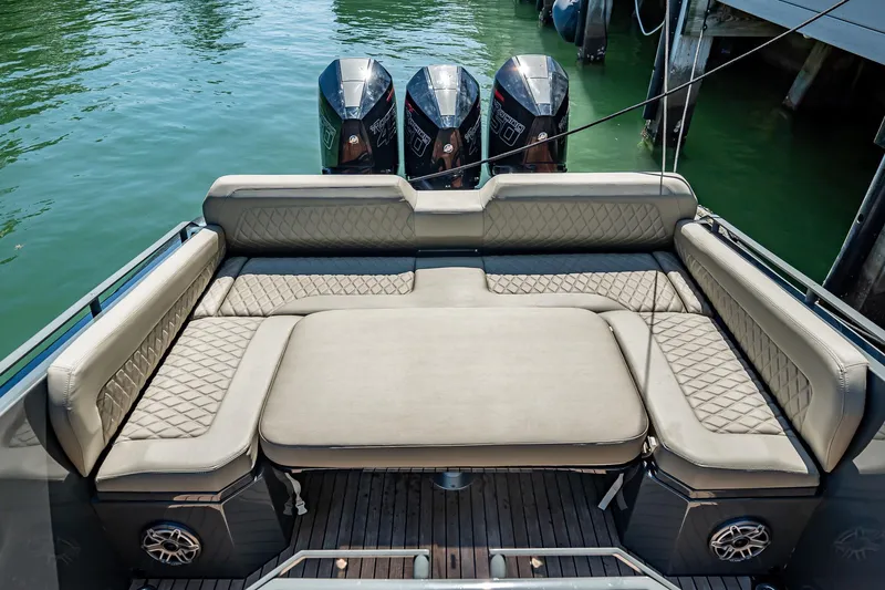 Slide: The Image of Luxurious seating area on 2023 Skipper-BSK 38NC boat with triple outboard engines. - 123