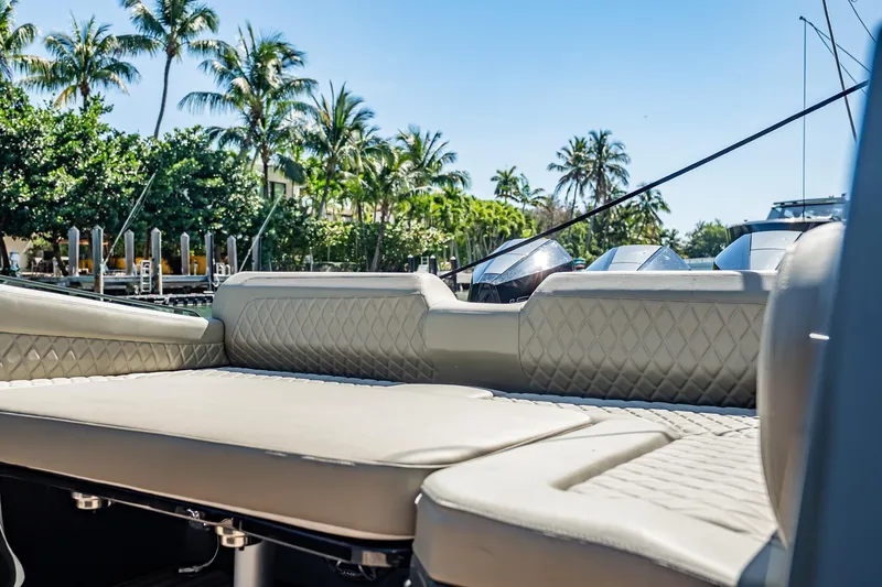 Slide: The Image of Luxurious seating on 2023 Skipper-BSK 38NC boat with palm trees in background. - 126