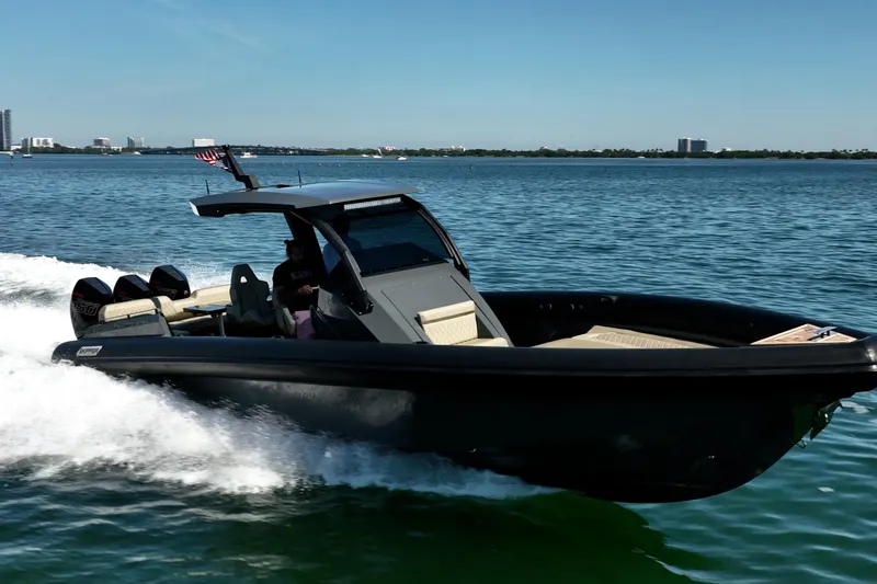 Slide: The Image of 2023 Skipper-BSK 38NC boat cruising on open water, showcasing sleek design and powerful engines. - 19