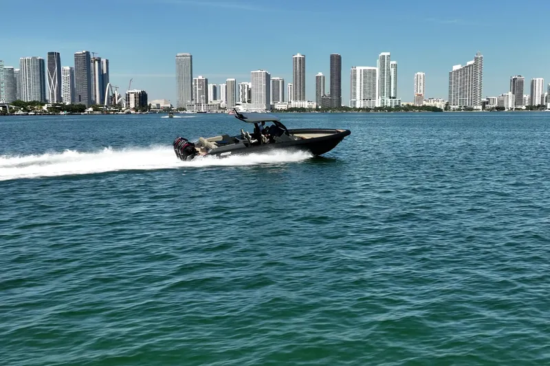 Slide: The Image of Speedboat Skipper-BSK 38NC cruising near city skyline, 2023 model. - 2