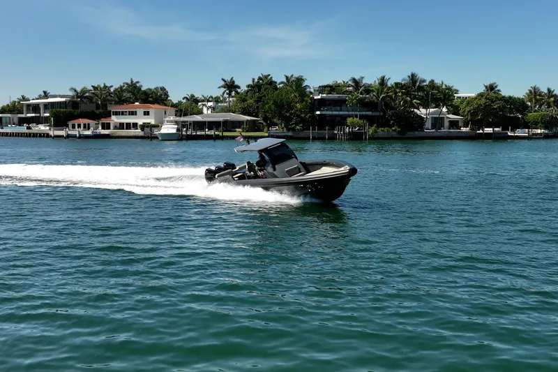 Slide: The Image of 2023 Skipper-BSK 38NC speedboat cruising on a sunny waterfront. - 23