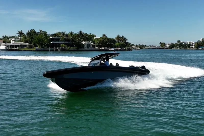 Slide: The Image of 2023 Skipper-BSK 38NC speedboat cruising on a sunny, tropical waterway. - 24