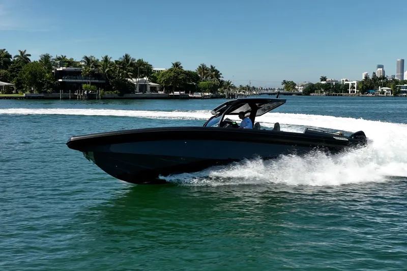 Slide: The Image of 2023 Skipper-BSK 38NC speedboat cruising on a sunny day near a coastal city. - 25