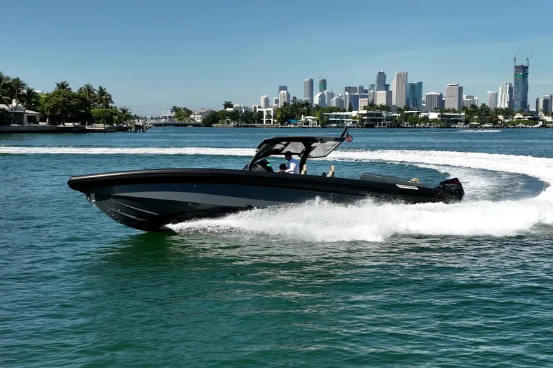 Slide: The Image of 2023 Skipper-BSK 38NC boat cruising in a scenic waterfront cityscape. - 26