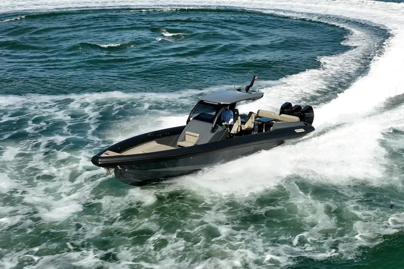 Slide: The Image of 2023 Skipper-BSK 38NC boat making a sharp turn on open water. - 28