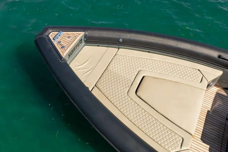 Slide: The Image of Bow of 2023 Skipper-BSK 38NC boat with beige quilted seating on turquoise water. - 30
