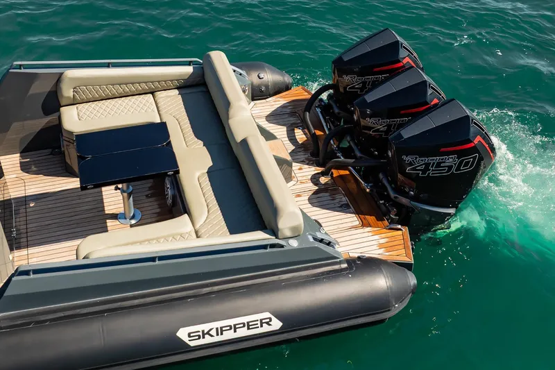 Slide: The Image of Luxurious 2023 Skipper-BSK 38NC boat with triple engines and elegant seating on water. - 31