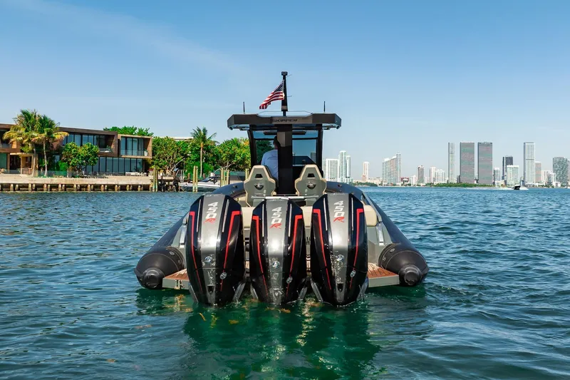 Slide: The Image of Skipper-BSK 38NC 2023 boat with triple engines on a sunny waterfront. - 35