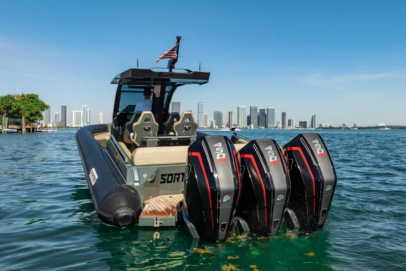 Slide: The Image of Skipper-BSK 38NC boat with triple 450R engines on water, city skyline in background. - 36